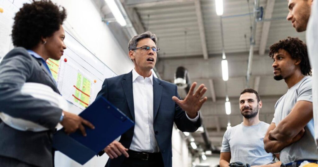Manager communicating change to team members in the workplace