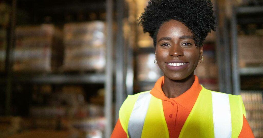 female warehouse worker smiling at camera