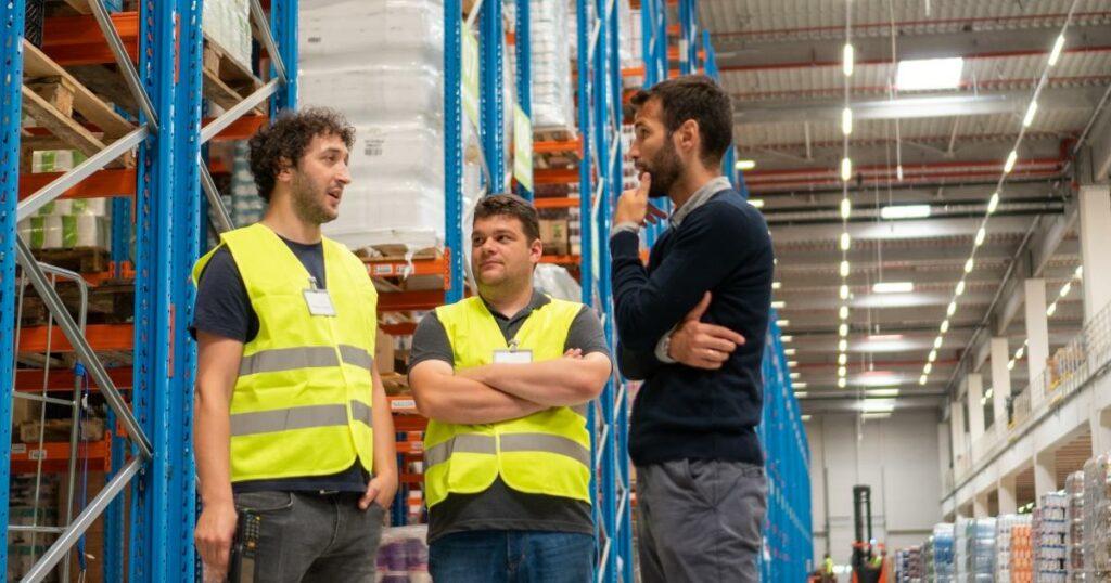 recruiter talking to workers in warehouse