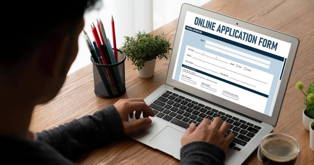 Job applicant completing an online application form on a laptop, illustrating how AI hiring tools process candidate data during the recruitment process